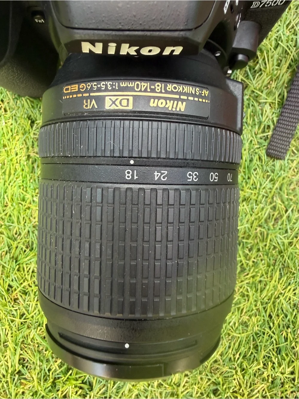 Nikon D7500 DSLR Camera with Black Lens and Red Strap